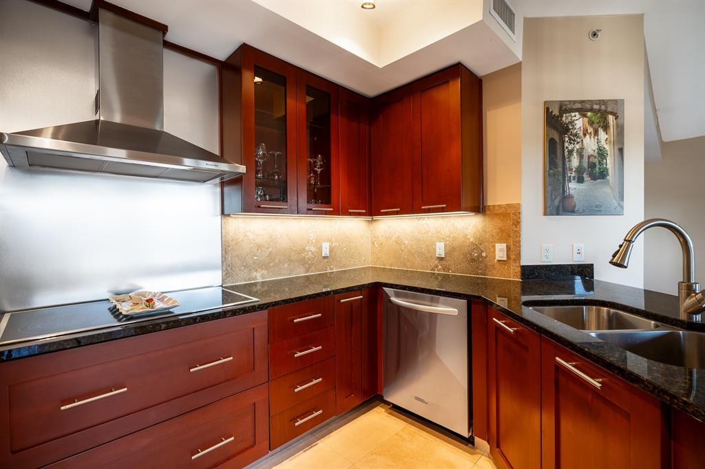 2401 North Ocean Boulevard, Unit 403 Fort Lauderdale, FL 33305 - Photo 9 of 32 a kitchen with granite countertop a sink cabinets and stainless steel appliances