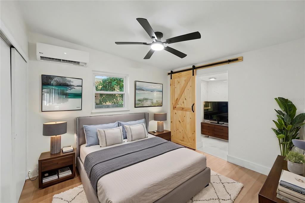 9482 Crestview Street Seminole, FL 33772 - Photo 15 of 35 a bedroom with a large bed and a window