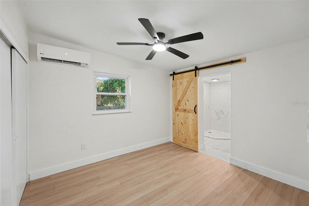 9482 Crestview Street Seminole, FL 33772 - Photo 16 of 35 a view of empty room with wooden floor and fan