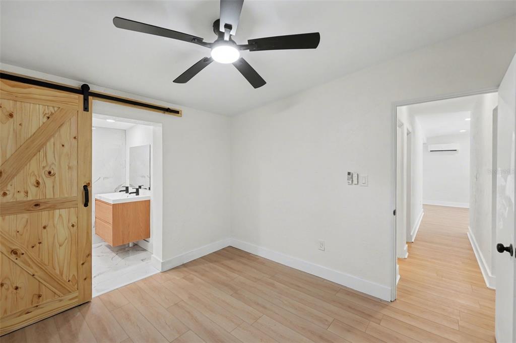9482 Crestview Street Seminole, FL 33772 - Photo 17 of 35 wooden floor in an empty room with a window