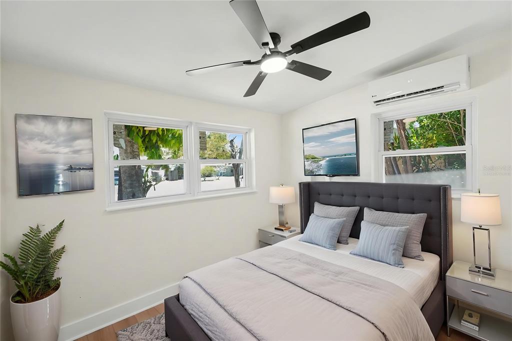9482 Crestview Street Seminole, FL 33772 - Photo 20 of 35 a bedroom with a large bed and a potted plant