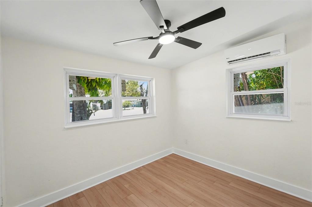 9482 Crestview Street Seminole, FL 33772 - Photo 21 of 35 a view of an empty room with wooden floor and a window