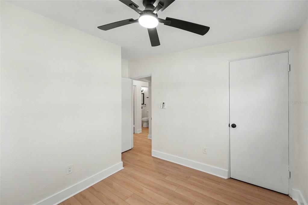 9482 Crestview Street Seminole, FL 33772 - Photo 22 of 35 a view of an empty room with wooden floor