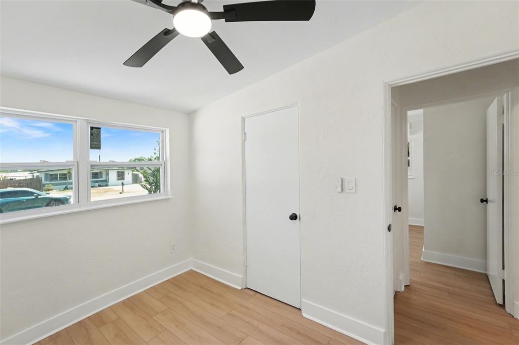 9482 Crestview Street Seminole, FL 33772 - Photo 23 of 35 a view of empty room with wooden floor and window