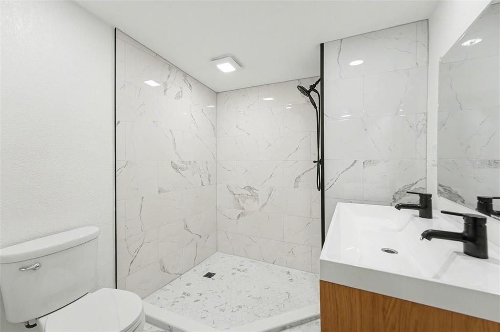 9482 Crestview Street Seminole, FL 33772 - Photo 24 of 35 a bathroom with a sink toilet and shower