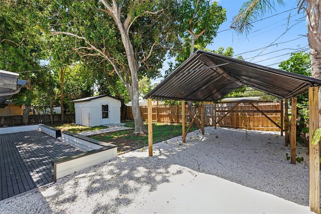 9482 Crestview Street Seminole, FL 33772 - Photo 30 of 35 a backyard of a house with barbeque oven table and chairs