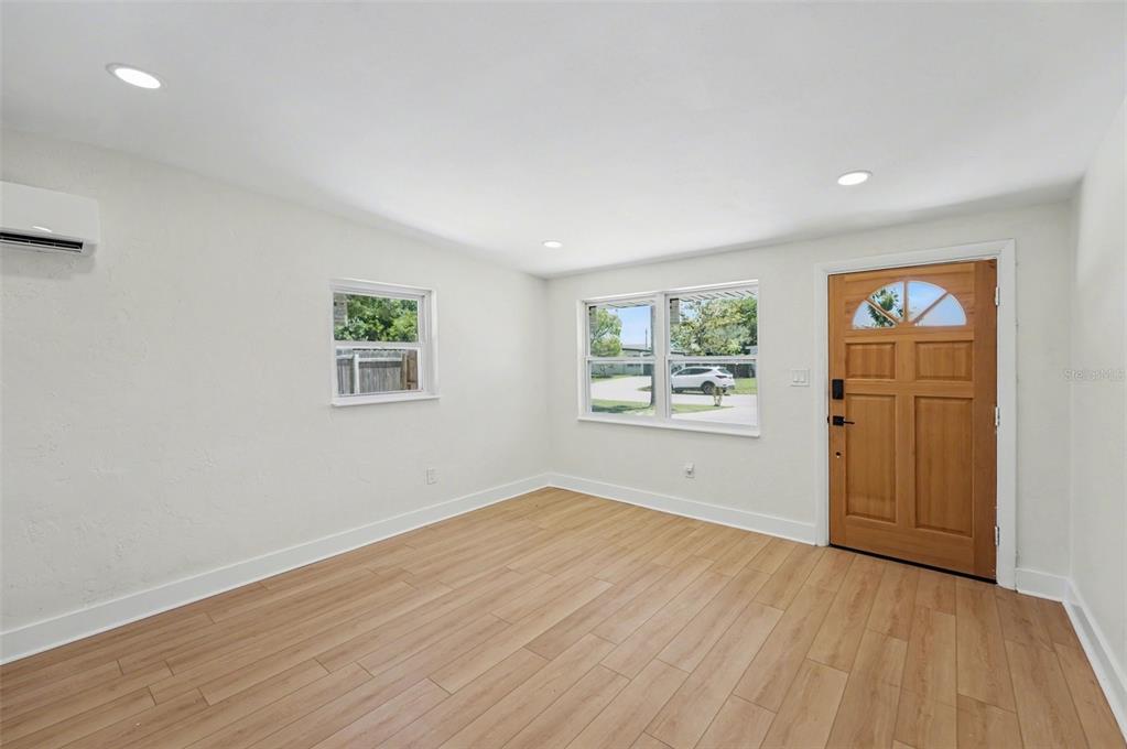9482 Crestview Street Seminole, FL 33772 - Photo 6 of 35 a view of empty room with wooden floor and fan
