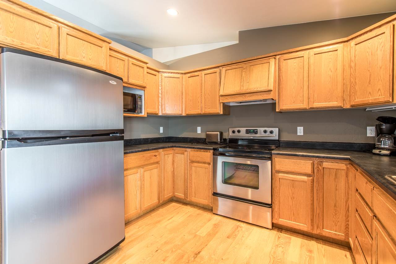 1112 Q Road Mack, CO 81525 - Photo 8 of 35 a kitchen with a sink a refrigerator and cabinets