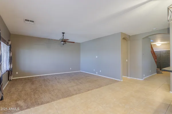 a view of a livingroom with a ceiling fan and window