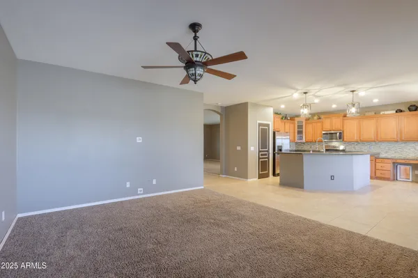 a view of a room with a ceiling fan and a fan