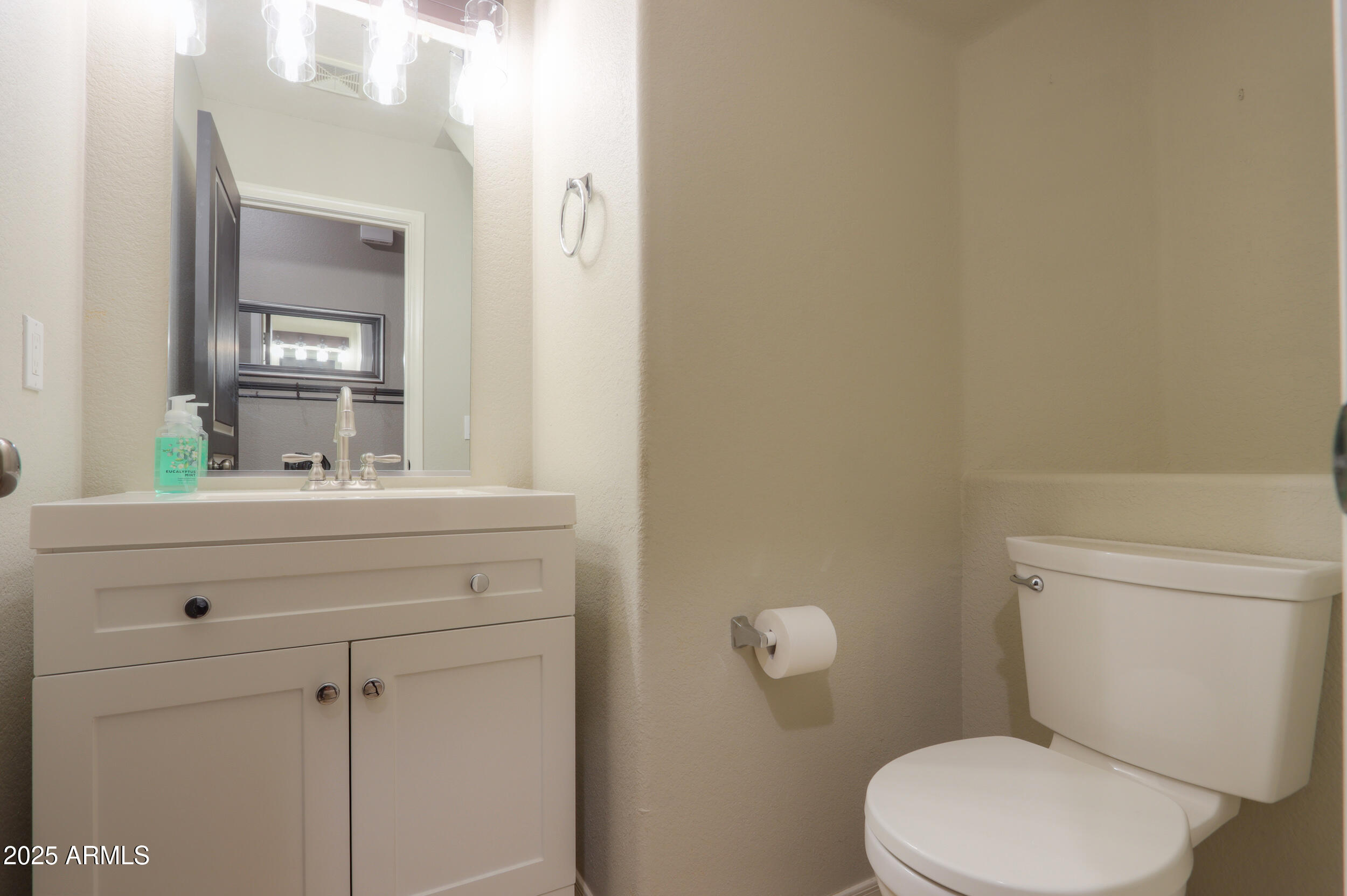 44254 Adobe Circle Maricopa, AZ 85139 - Photo 27 of 71 a bathroom with a toilet a sink a mirror and vanity