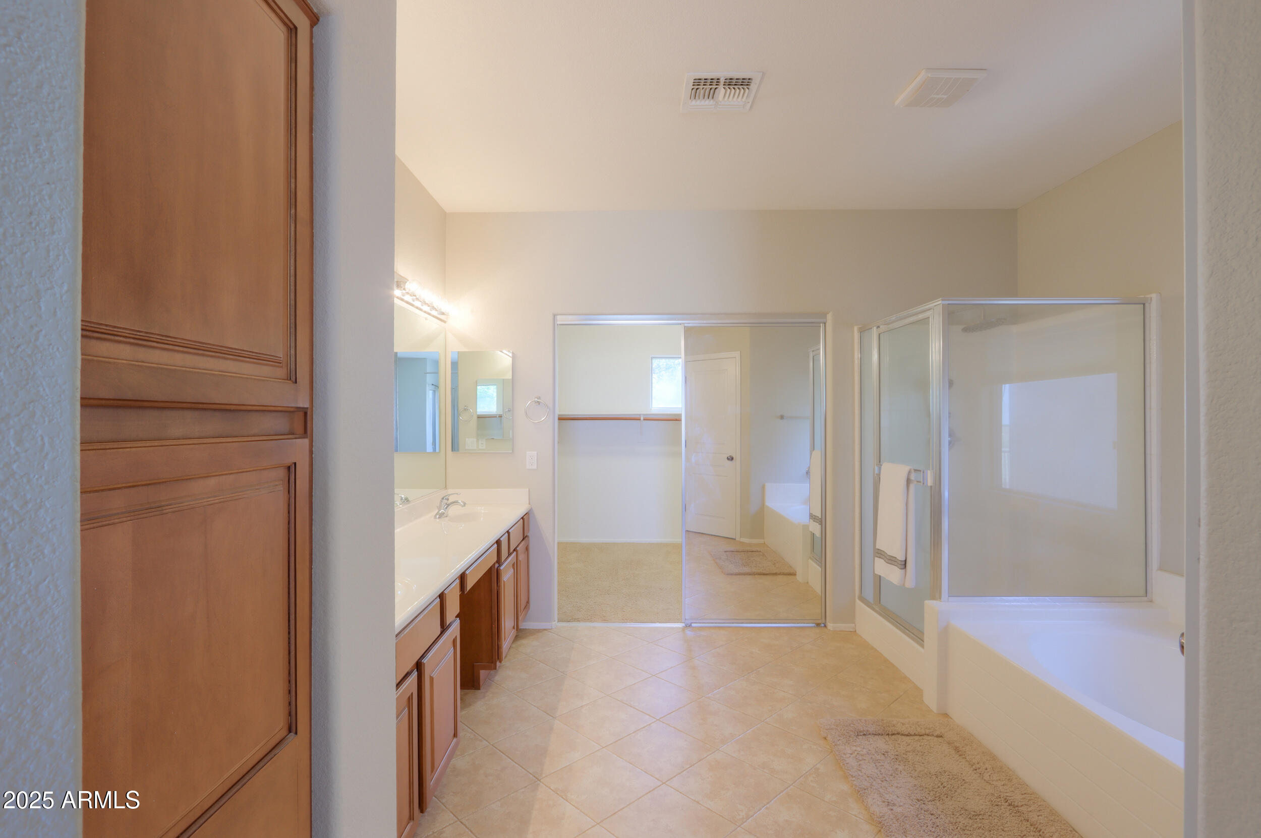 44254 Adobe Circle Maricopa, AZ 85139 - Photo 45 of 71 a bathroom with a glass shower door and a mirror