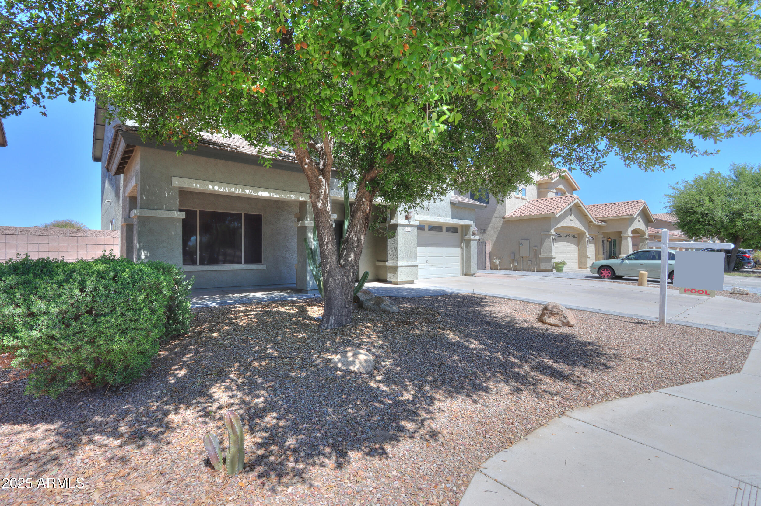 44254 Adobe Circle Maricopa, AZ 85139 - Photo 9 of 71 a front view of a house with a tree