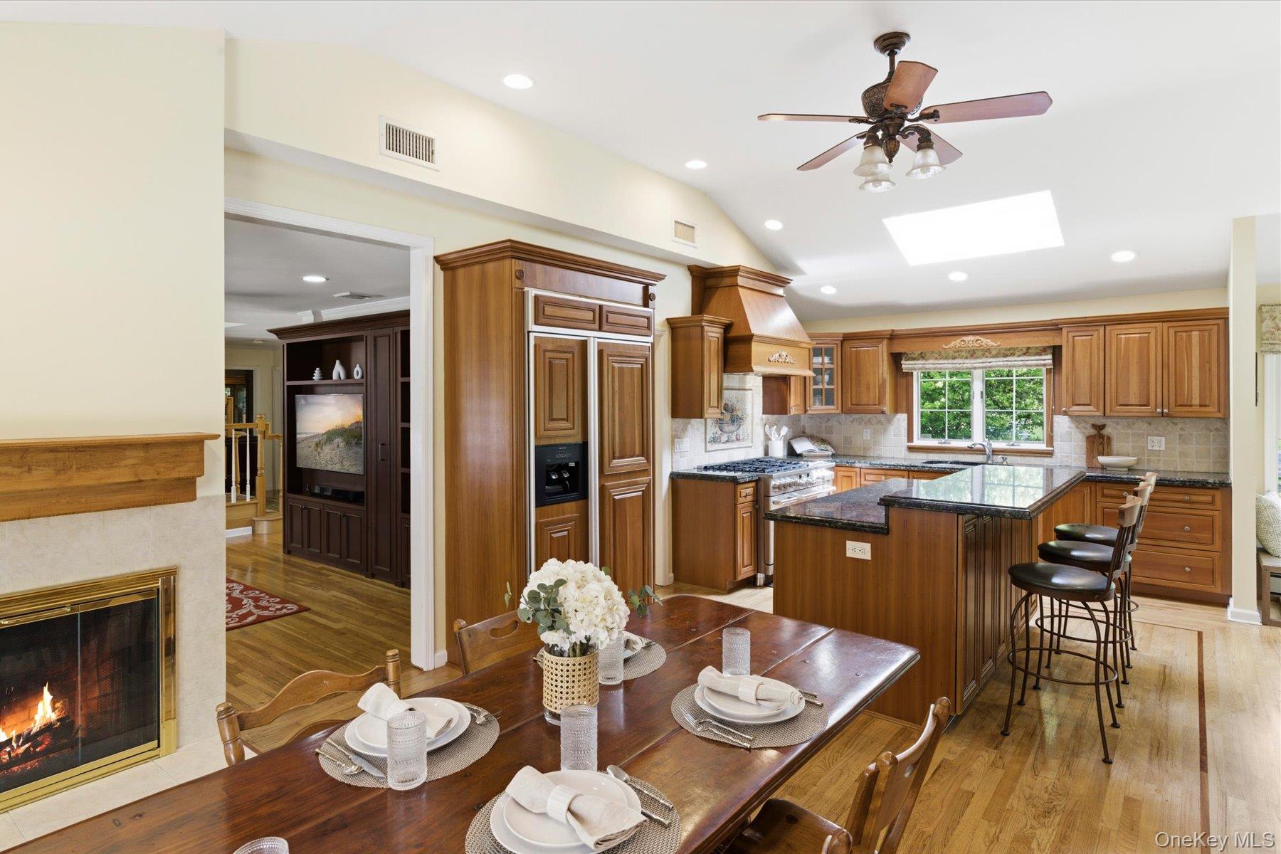 6 Brandy Road Cold Spring Harbor, NY 11724 - Photo 5 of 25 a view of a dining room with furniture a kitchen and chandelier