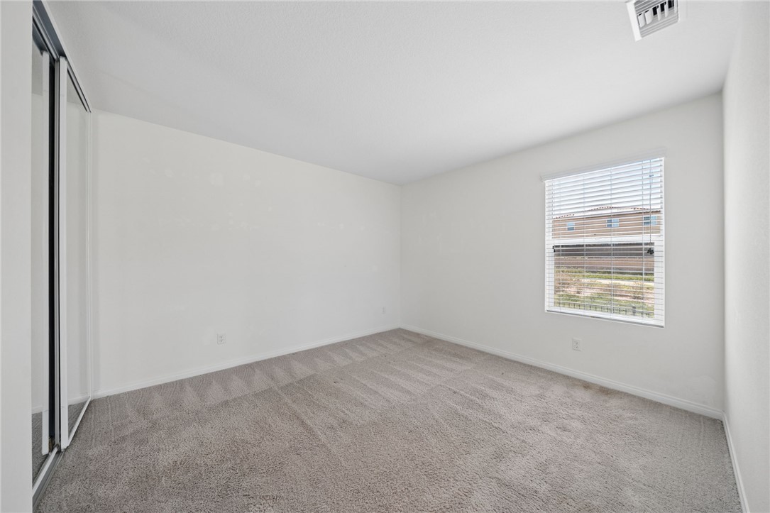 20130 Curaco Court Riverside, CA 92507 - Photo 33 of 43 Bright secondary bedroom with neutral carpet and a window.