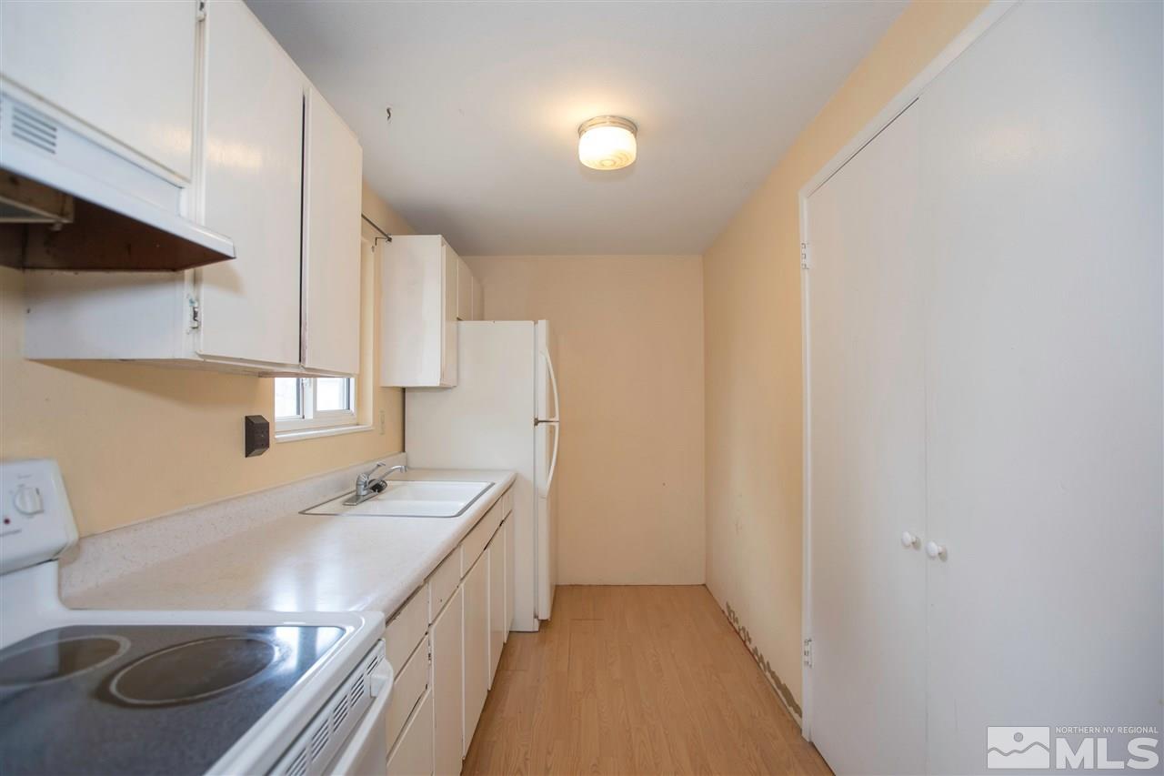 9055 Reservoir Street Reno, NV 89506 - Photo 9 of 15 a kitchen with stainless steel appliances a sink and a refrigerator