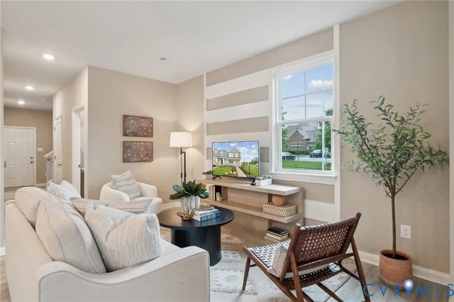 a living room with furniture and a potted plant