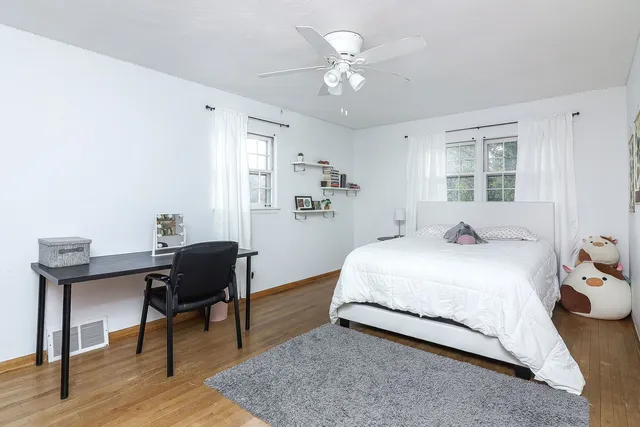 a bedroom with a bed and a desk