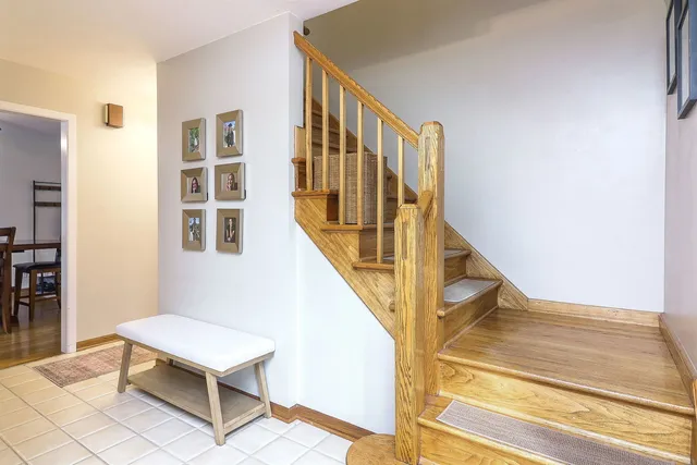 a view of a hallway with wooden floor and staircase