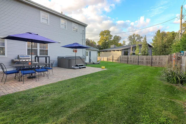 a view of a house with a backyard patio and swimming pool