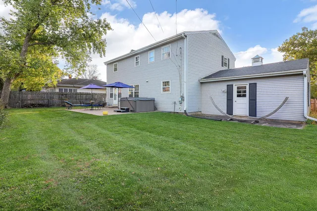 a view of a house with a yard and sitting area