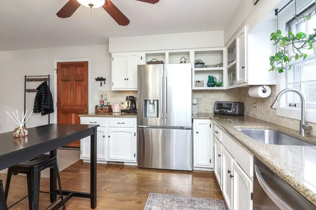 a kitchen with a refrigerator a stove a sink and a wooden cabinets