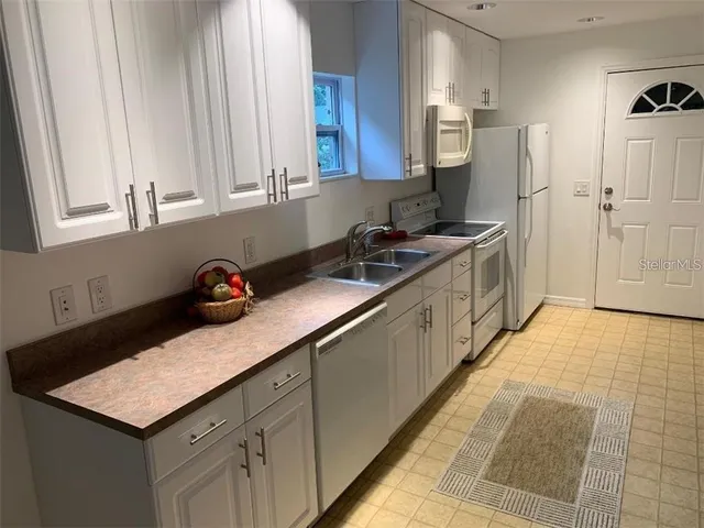 a kitchen with a sink and cabinets