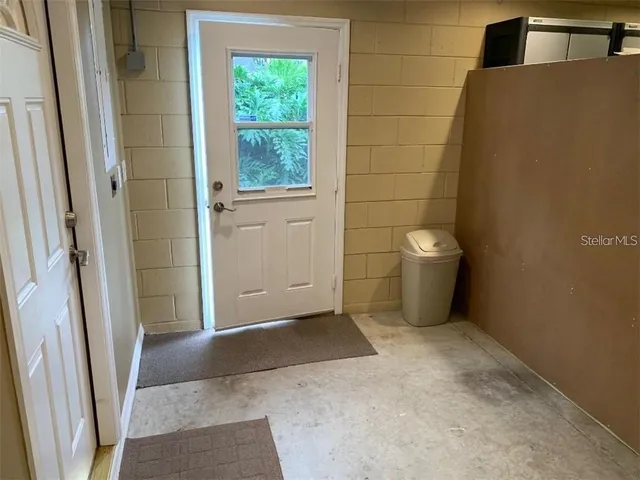 a view of a room with a wooden door