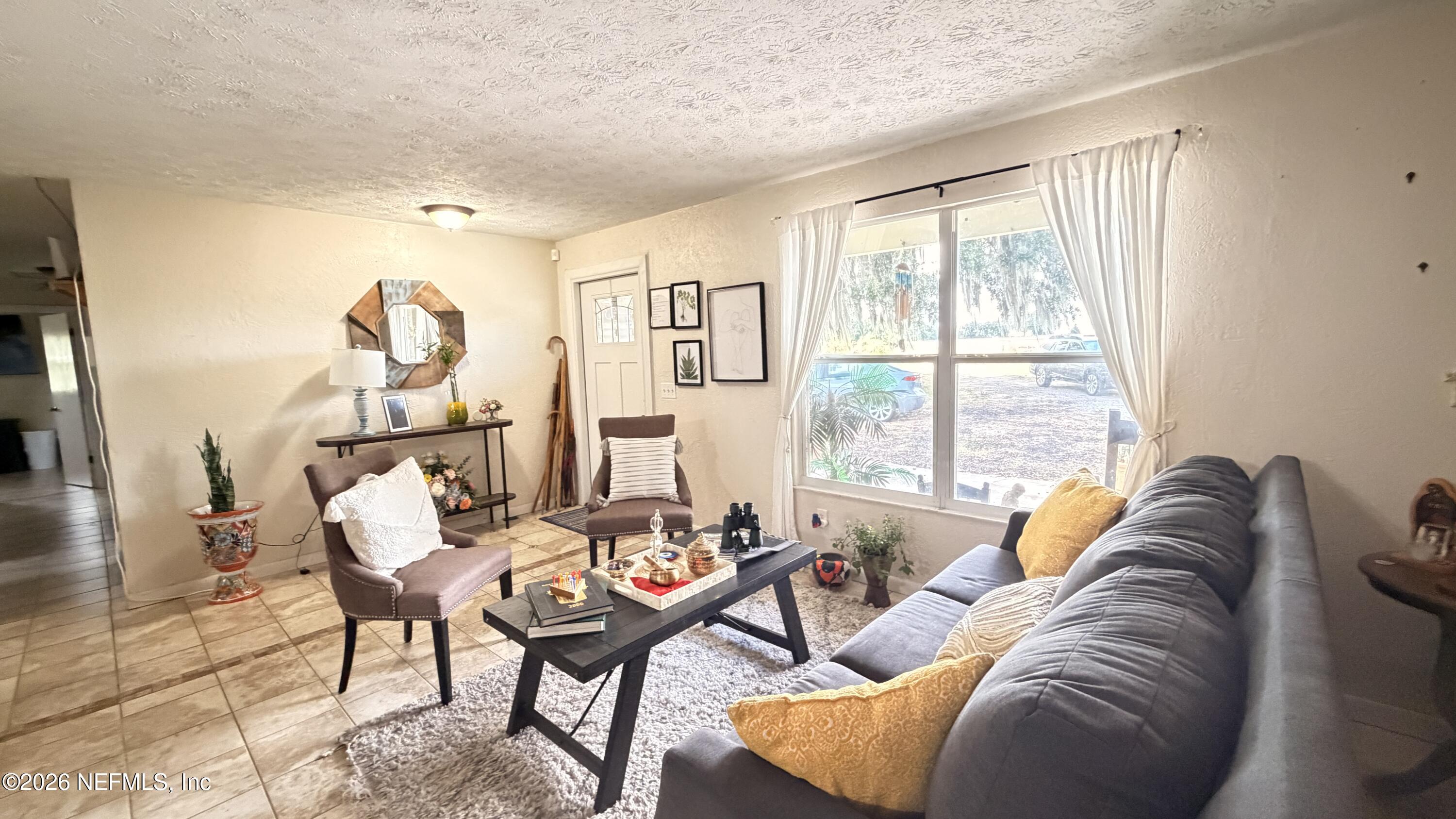 1302 Fort Meade Road Frostproof, FL 33843 - Photo 23 of 39 a living room with furniture and a window