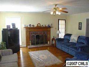 16832 Plaincrest Road Midland, NC 28107 - Photo 5 of 8 a living room with furniture and a fireplace