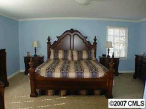 16832 Plaincrest Road Midland, NC 28107 - Photo 6 of 8 a bed sitting in a bedroom next to a window