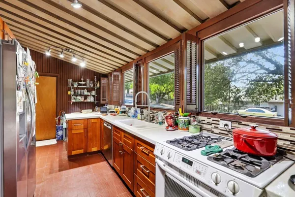 a kitchen with stainless steel appliances granite countertop a stove a sink dishwasher and cabinets