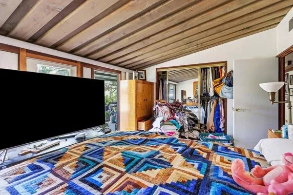 a bed room with a bed and a flat screen tv