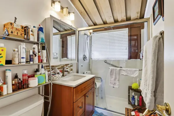 a bathroom with a sink mirror and vanity