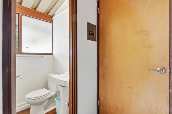 a white toilet sitting next to a bathroom sink