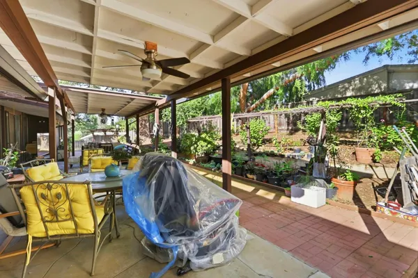 a view of a patio with a dining table and chairs