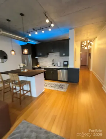 a kitchen with a sink cabinets and wooden floor