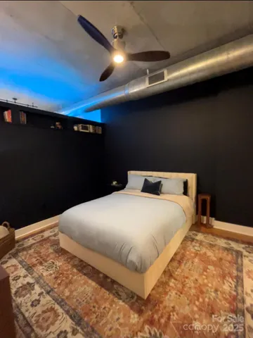 a large bed sitting in a bedroom next to a lamp