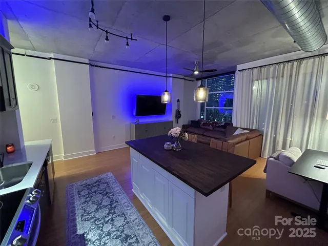 a kitchen with stainless steel appliances granite countertop a sink a stove and a refrigerator