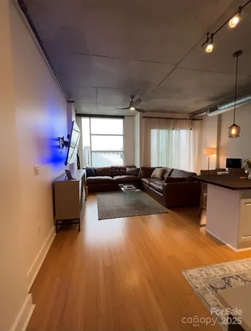 a large room with pool table and windows
