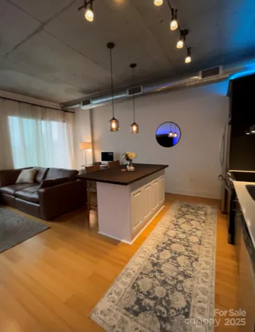 a kitchen with stainless steel appliances kitchen island granite countertop a sink and a stove