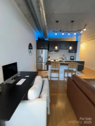 a kitchen with stainless steel appliances kitchen island granite countertop a stove a sink and a refrigerator