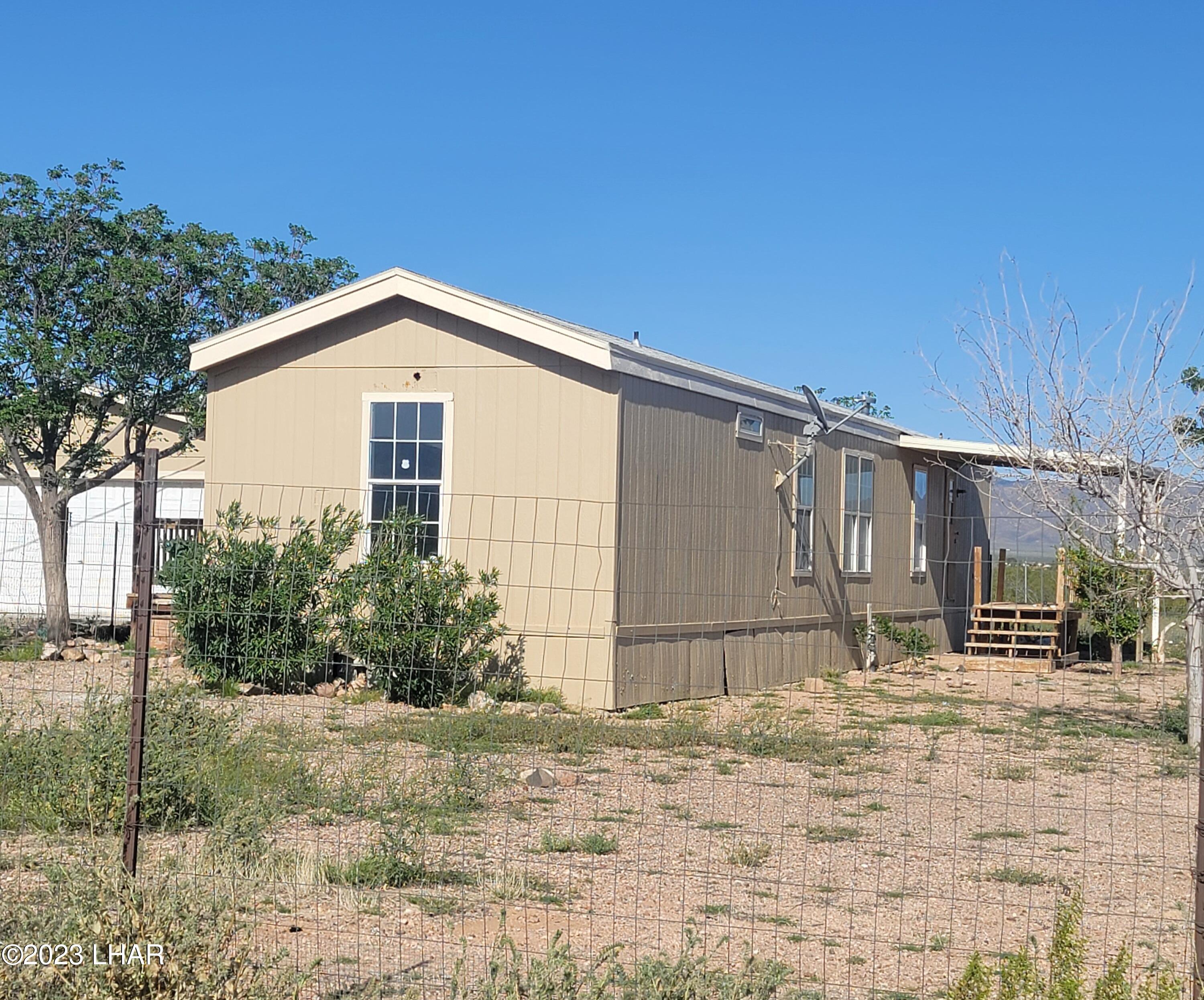4944 Elgin Road Golden Valley, AZ 86413 - Photo 2 of 14 a front view of a house with garden