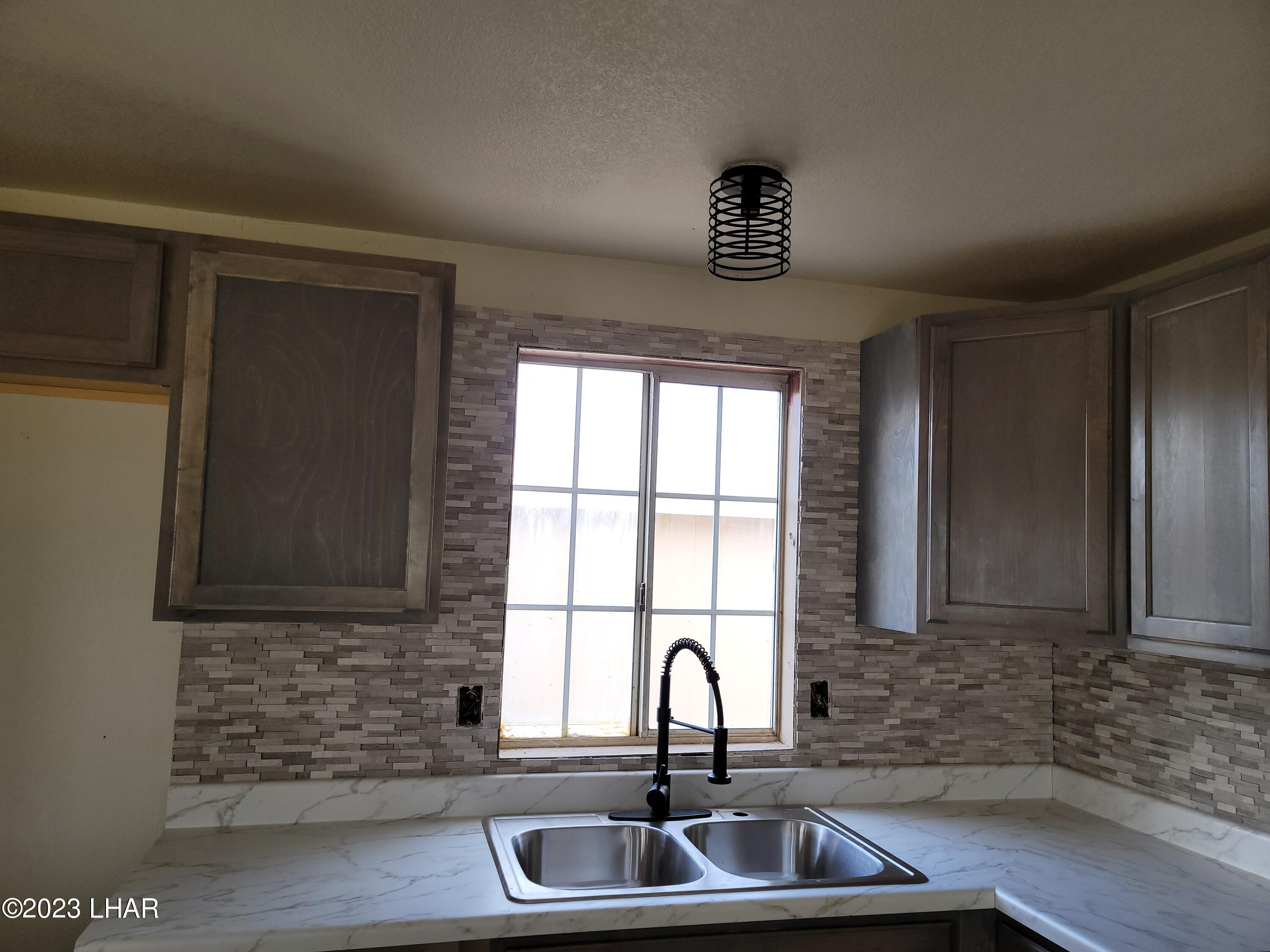 4944 Elgin Road Golden Valley, AZ 86413 - Photo 9 of 14 a kitchen with a sink and a window