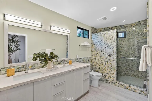 a bathroom with a sink mirror and toilet