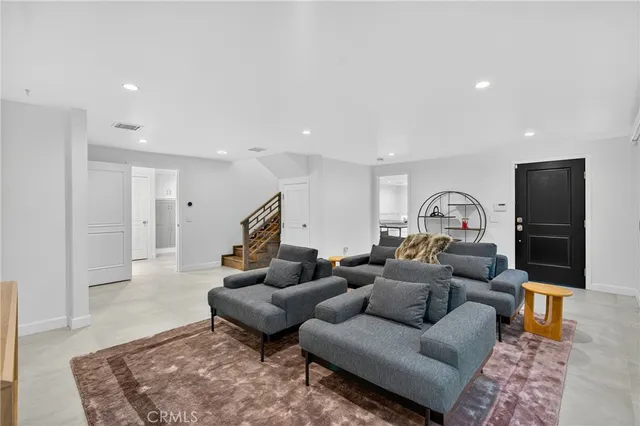 a living room with furniture and a rug