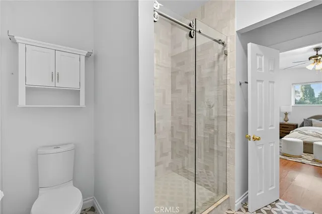 a bathroom with a toilet and a shower