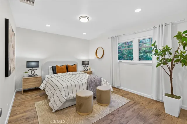a bedroom with a bed and a potted plant