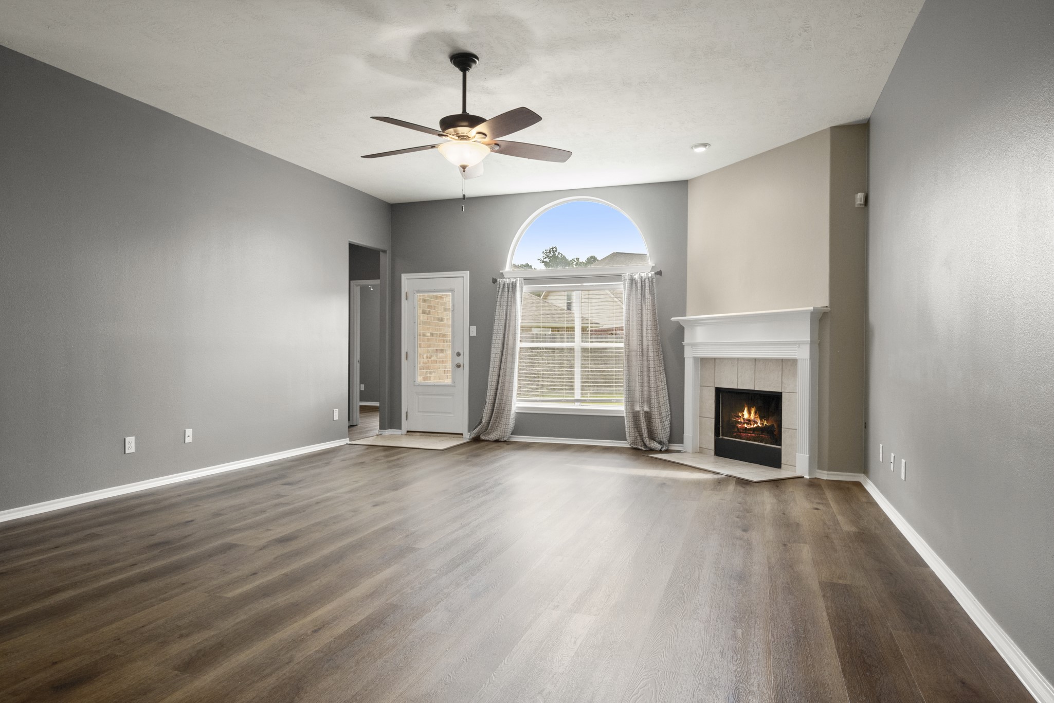 21702 Mileham Lane Spring, TX 77388 - Photo 8 of 22 Living room complete with fireplace, open to kitchen.