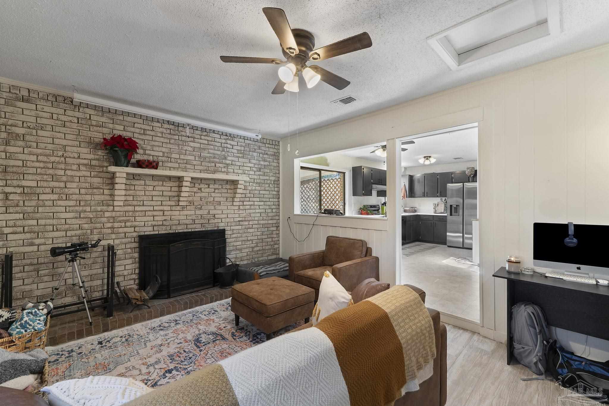 465 Ronda Street Pensacola, FL 32534 - Photo 14 of 48 a living room with furniture a fireplace and a flat screen tv